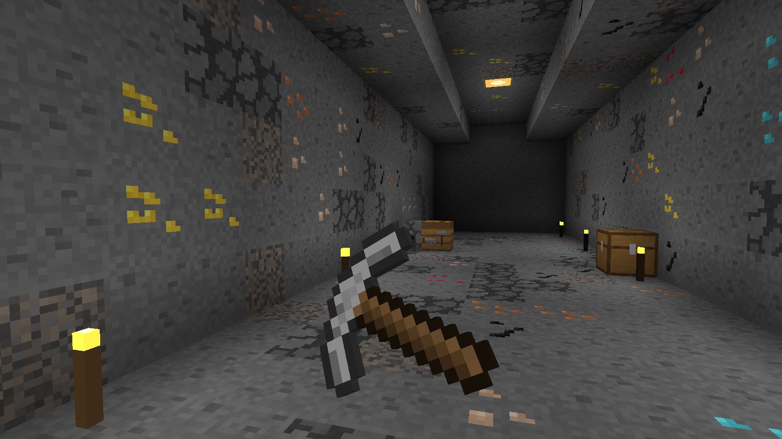 A torch-lit tunnel with gold, crystal and copper ore in the walls, an iron pickaxe in hand