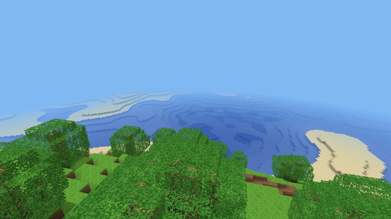 Green hills and sandbars along a blocky coastline